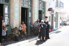 even the bishop of kythera has need to visit potamo on sundays, seen here greeted by one of the '' potamitidis' after a church service at potamo and some of the people are more interested playing with their mobile!! !