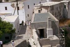The house of Rosa. 

It is the last house on the left as you enter the precinct of the Kastro in Hora.

(View looking down from the Kastro. The house in question is the unpainted house, at the top of the stairs, with scaffolding on the right hand side wall.)

In mid 2008 it was being...