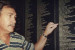Peter Sophios pointing to his father Dave&#039;s entry on the Welcome Wall 