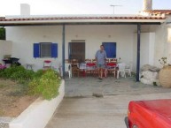 John G Prineas in front of the renovated house at Mitata 