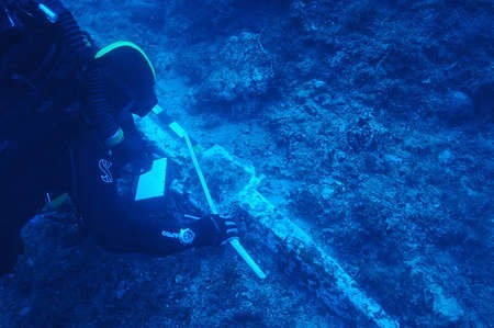 Theotokis Theodoulou examines the ship's lead anchor stock, about 1.4 metres long and weighing close to 200kg 