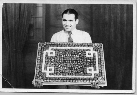 Harry Aliferis, holding a box of chocolates, to be used as a means of raising funds for the Greek War Relief Fund. 