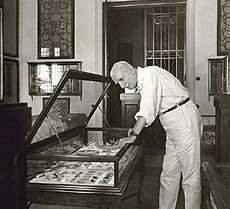 Antonis Benakis observing a case which contains ancient greek jewelry,1940-1950. Benaki Museum Historical  Archives. 