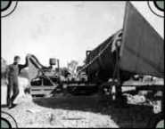 Peter Christianos Snr standing next to a dry rumbler in Lightning Ridge, c. 1961 