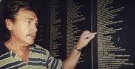 Peter Sophios pointing to his father Dave's entry on the Welcome Wall 