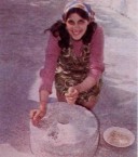 Matina Hiraki grinds corn on a grindstone... 