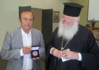 Metropolitan Seraphim of Kythera and Antikythera, admiring the Kytherian Medal of Honour 