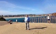 Mayor Theothori Koukoulis standing in front of one of the public sculptures 