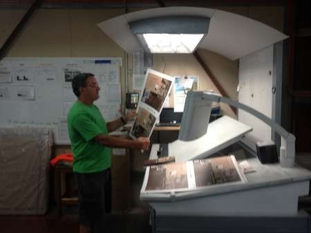 George C Poulos checks the results of the printed cover for Aphrodite and the Mixed Grill 