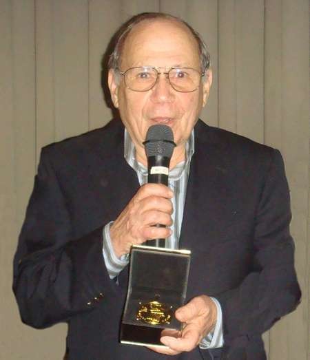 Angelo Notaras holding the Kytherian Medal of Honour - Angelo Notaras receives Kytherian Medal of Honour 3