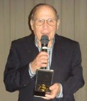 Angelo Notaras holding the Kytherian Medal of Honour 