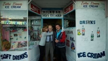 George Poulos with his daughter, Aphrodite, and son, Nik, outside his milk bar in 2014. 